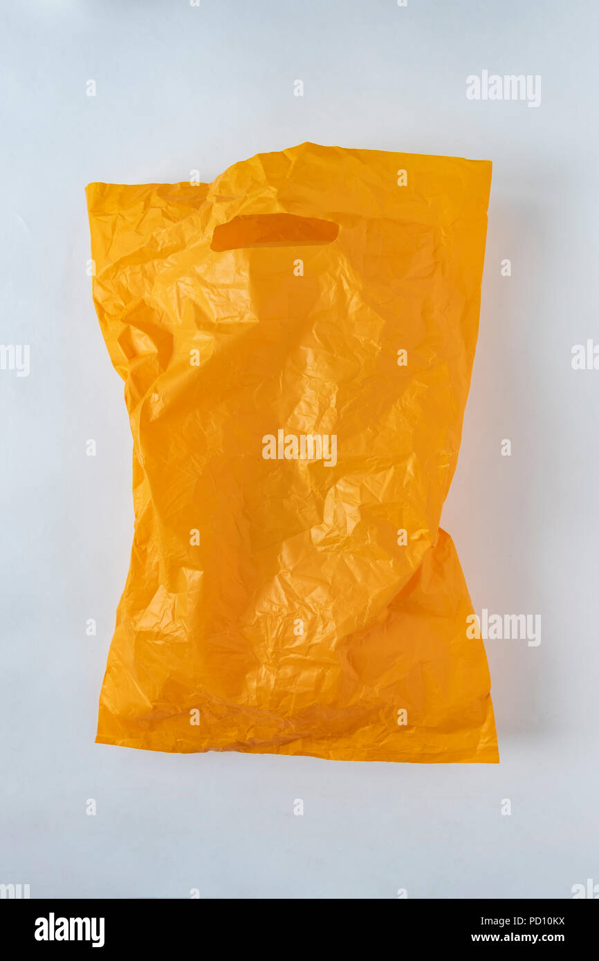 yellow plastic bag on a gray background Stock Photo