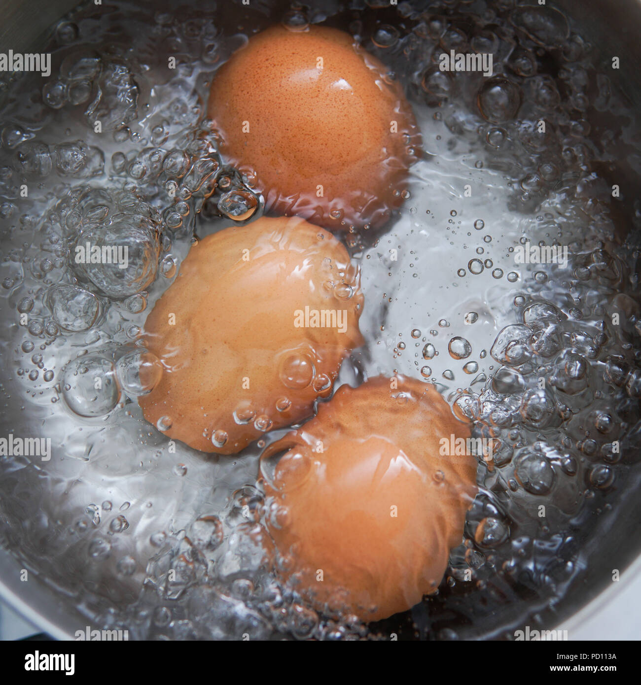 eggs in boiling water Stock Photo Alamy