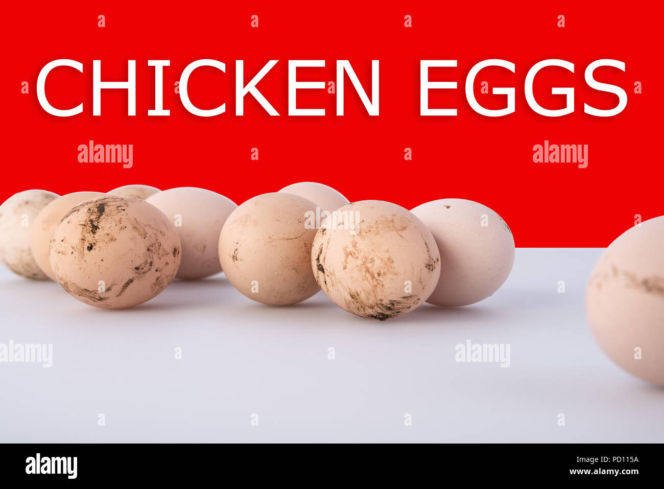 Group of dirty chicken eggs on gray background, with shadows and text