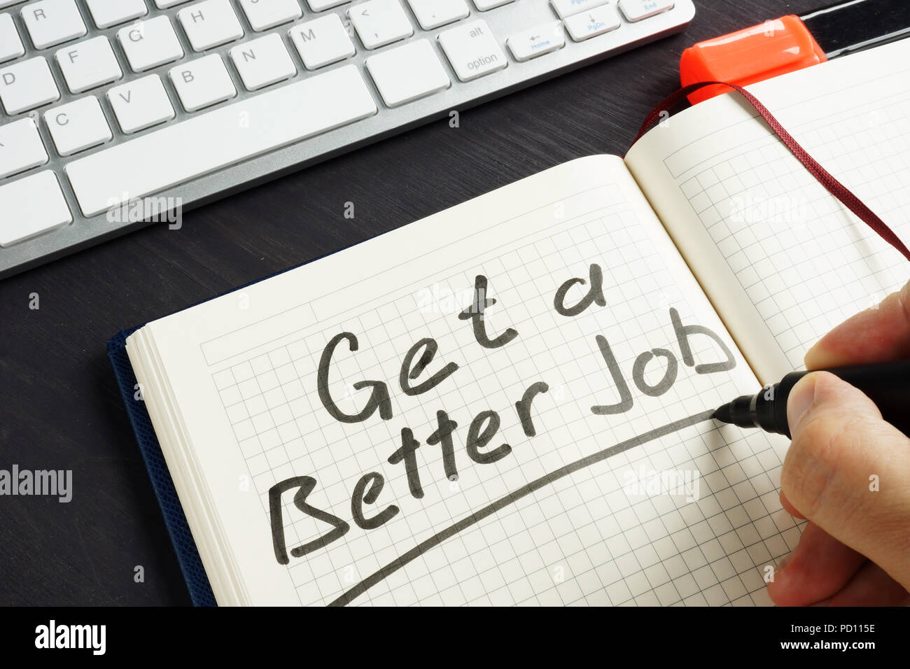 Get a Better Job handwritten in the note. Stock Photo