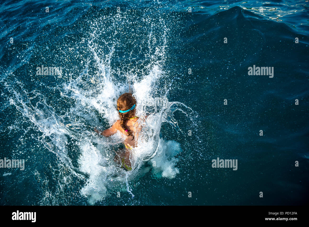 Trieste, Italy, 4 August 2018. A kid dives into the Adriatic Sea from a sailing boat.  Photo by Enrique Shore Stock Photo