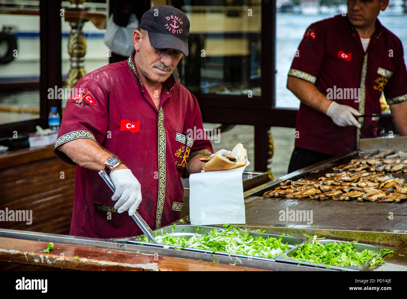 Cooks in fish sandwich restaurant boat, Eminonu, Istanbul, Turkey Stock