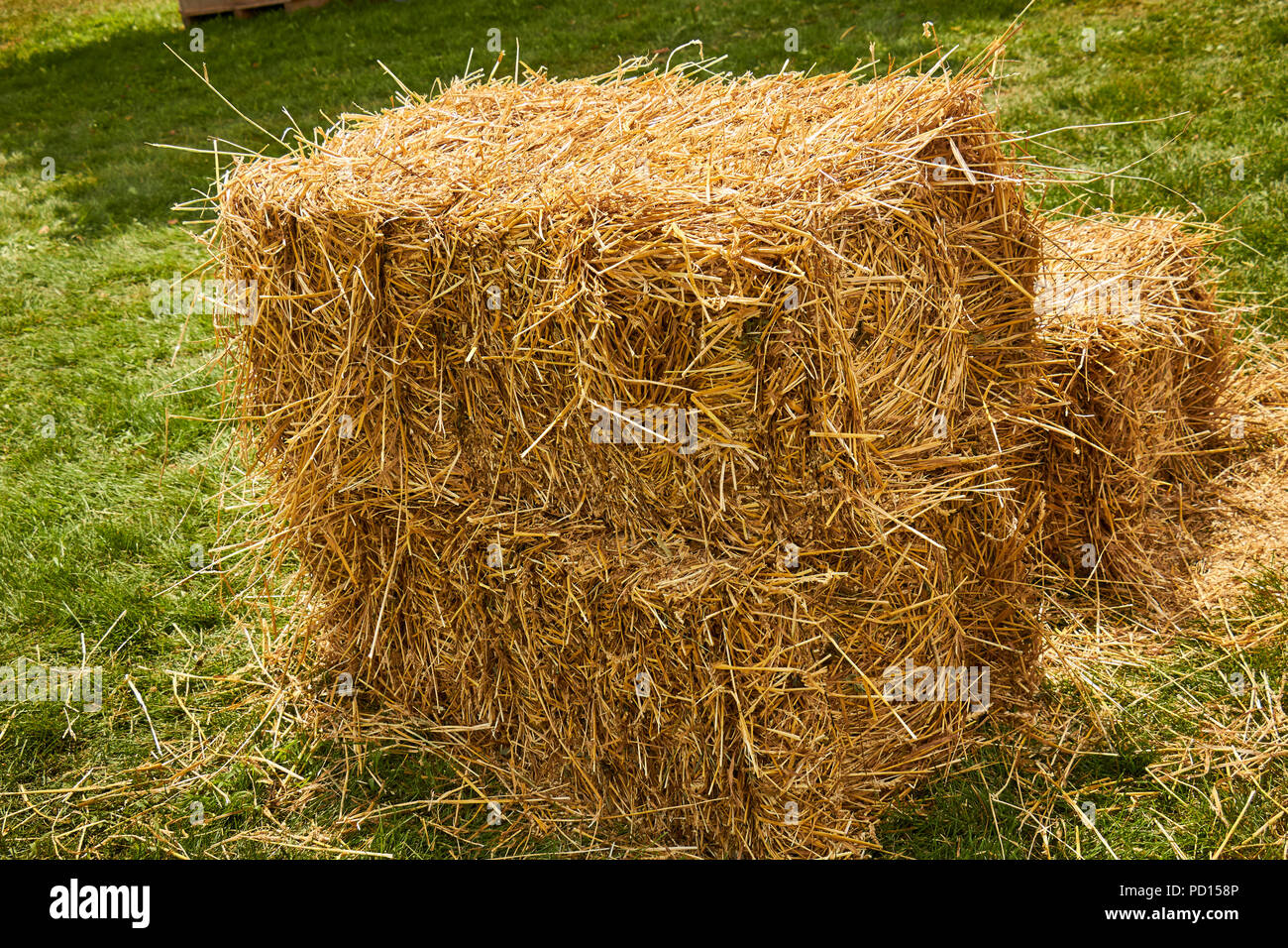 A square hay bale made from antique farm machinery Stock Photo