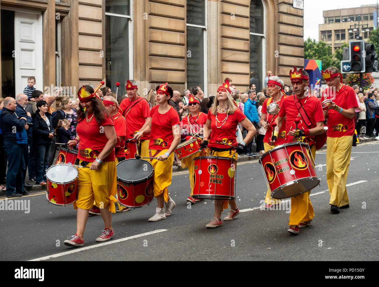 Samba band Bloco Fogo from Kent participating in the Carnival Procession of Glasgow's Merchant City Festival,.2018 Stock Photo
