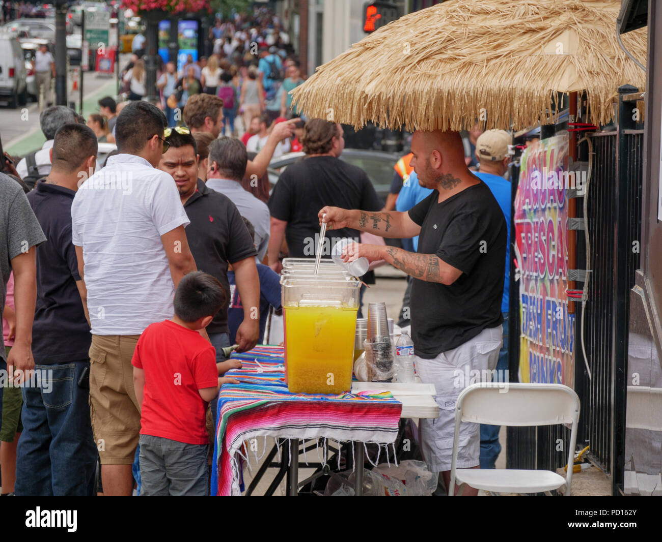 Man selling lemonade at lemonade stand, Randolph Street near Michigan