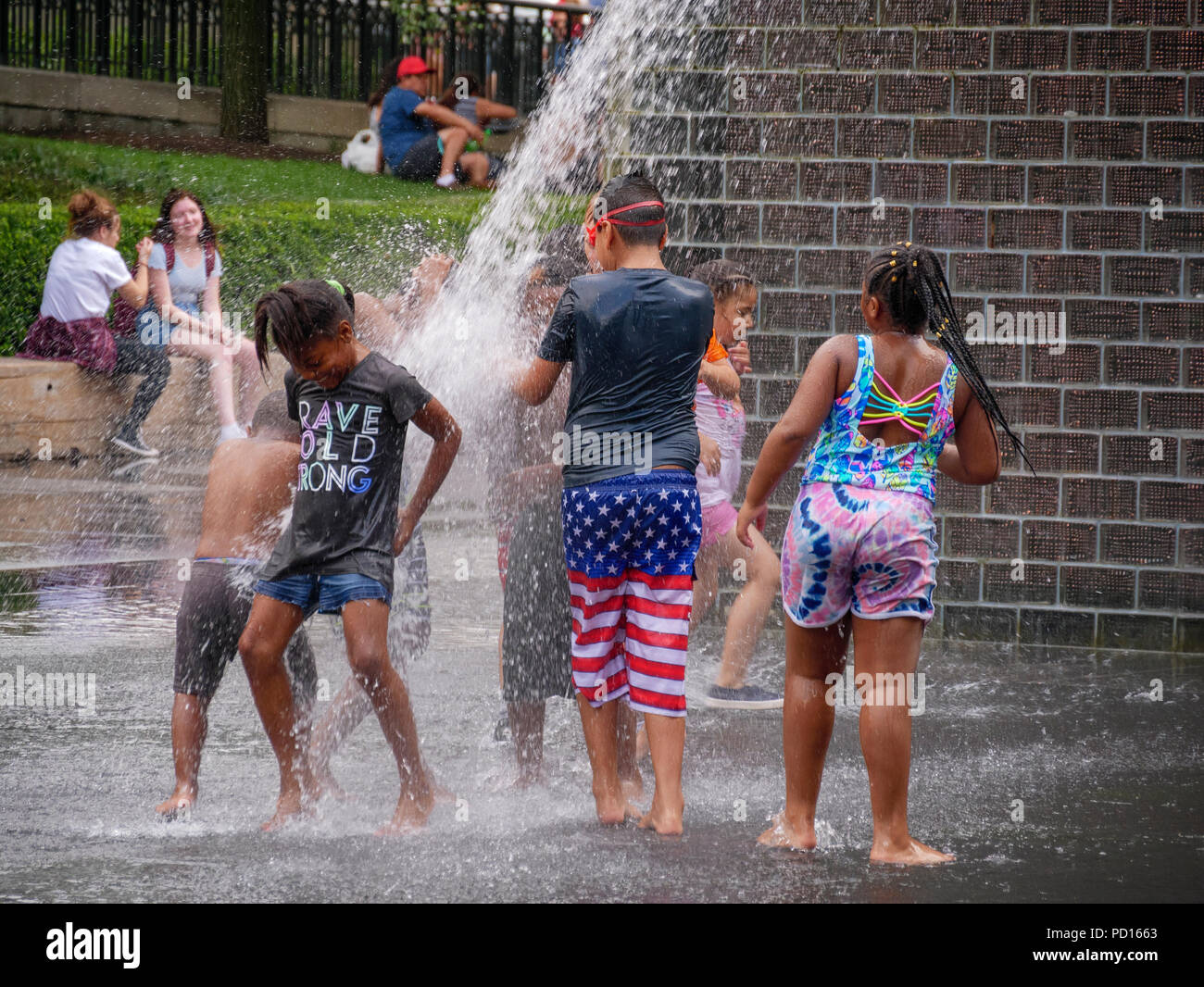 Children playing in the spray of Crown Fountain, Millennium Park, Chicago, Illinois. Stock Photo