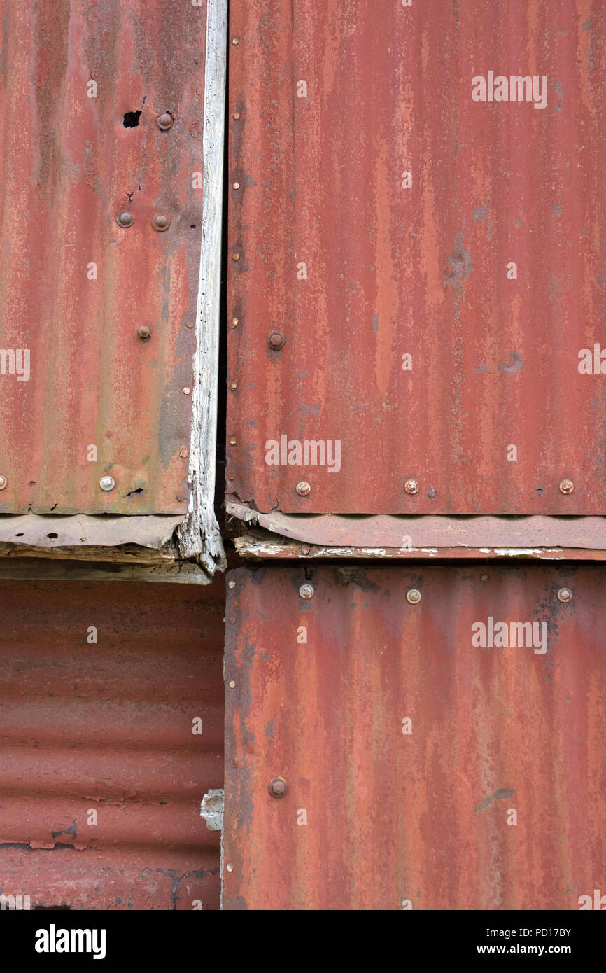 Rusting Corrugated sheets on a farm building as a background Stock Photo