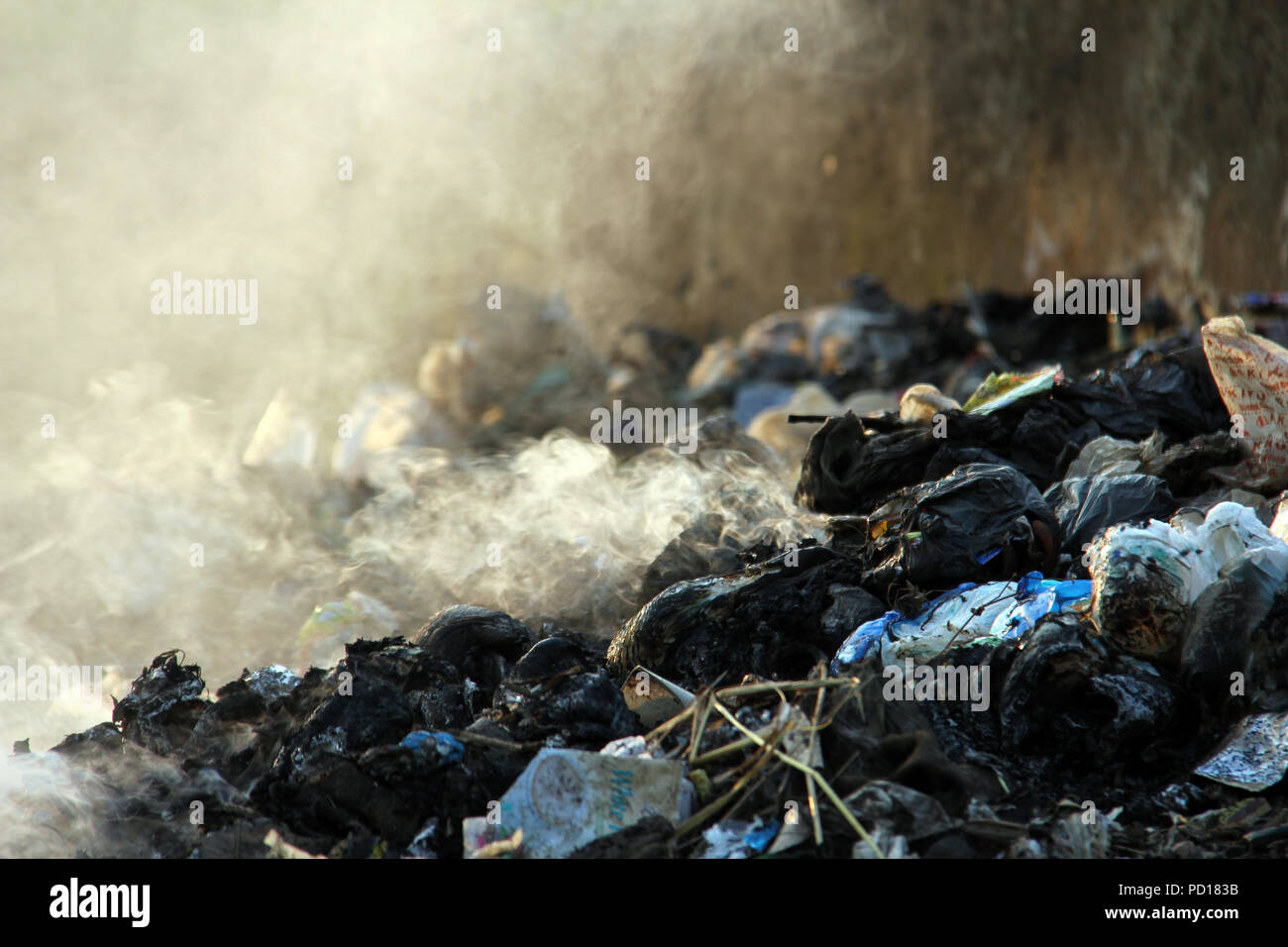 Burning plastic waste on the side of the road Stock Photo Alamy