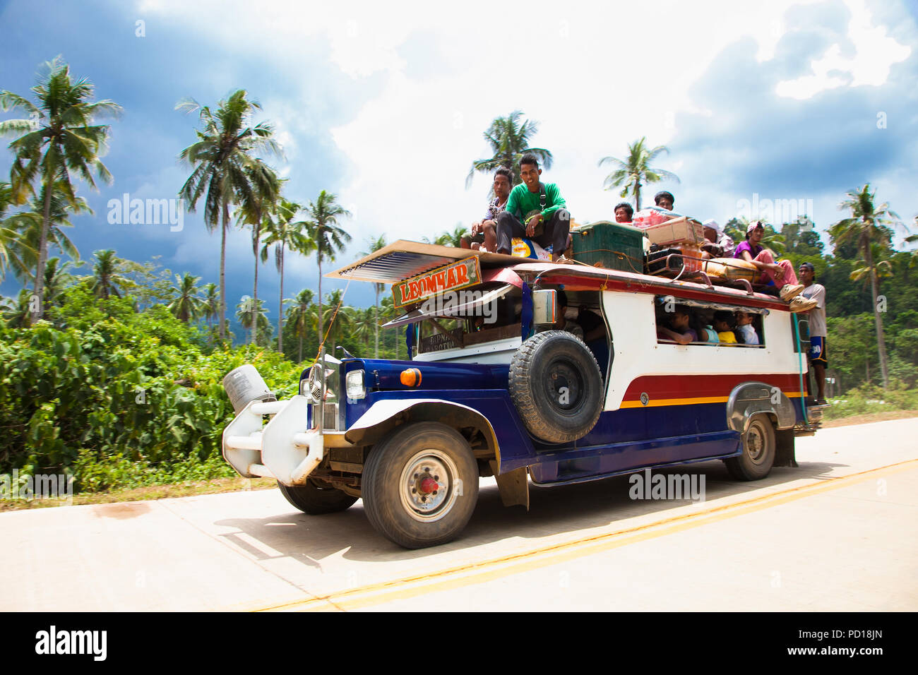 PALAWAN, PHILIPPINES- MARCH 28, 2106: Local people travel with public traditional transportation at Palawan island on March 28, 2016, Philippines. Stock Photo