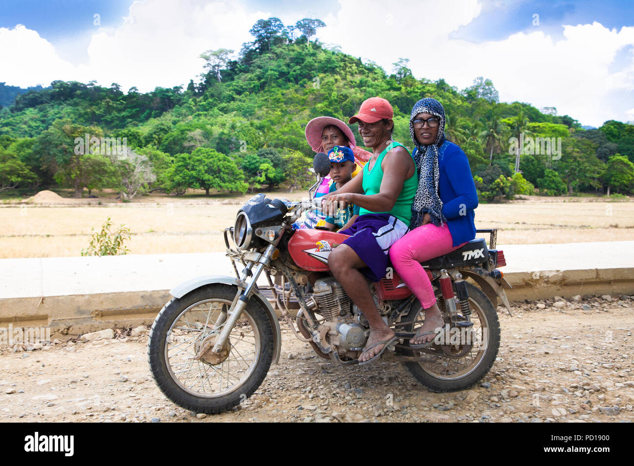 PALAWAN, PHILIPPINES- MARCH 28, 2106: Philippines family used motorcicle to travel at Palawan island on March 28, 2016, Philippines. Stock Photo