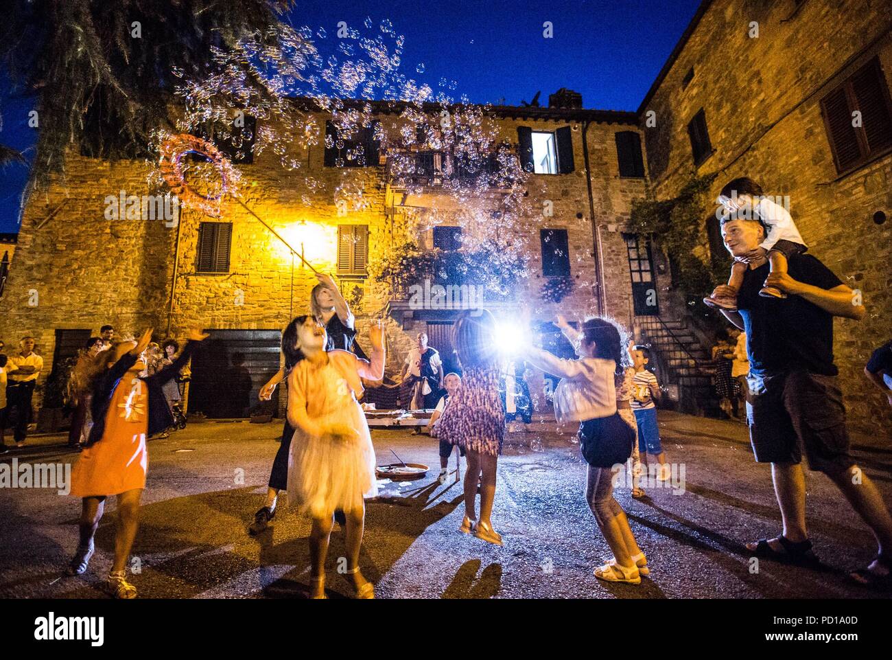 Castel Rigone, Italy. 3rd Aug, 2018. A woman blows bubbles during the Festival of the Barbarians in Castel Rigone, Italy, on Aug. 3, 2018. The Festival of the Barbarians, an event to commemorate the founding of the town, was held in Castel Rigone from Aug. 2 to 5. Credit: Jin Yu/Xinhua/Alamy Live News Stock Photo