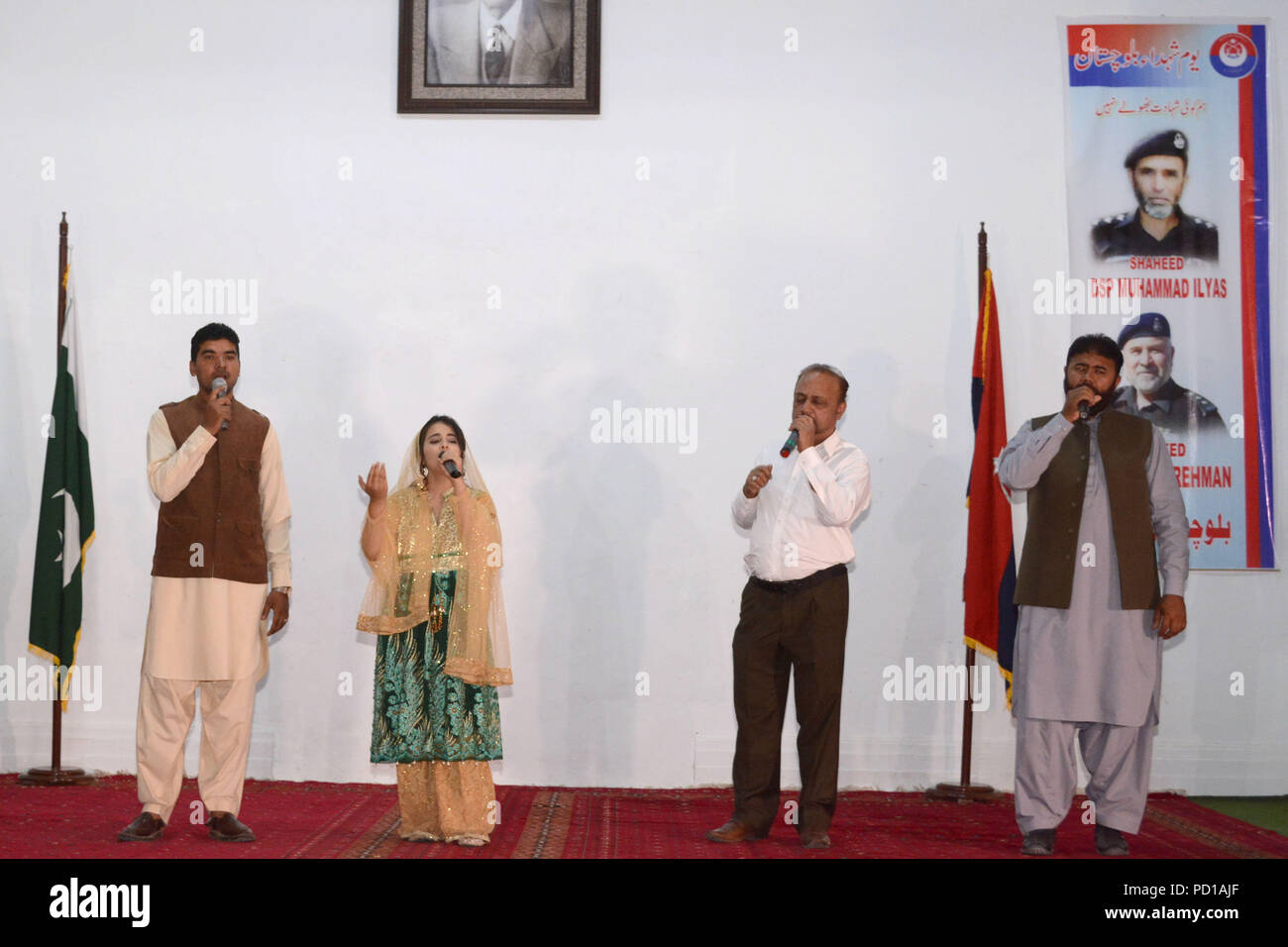 Quetta, Pakistan. August 04 2018: Pakistani singers Urooj Fatima and others performing national song on the stage during an event regarding National police day at police line in Quetta. Stock Photo