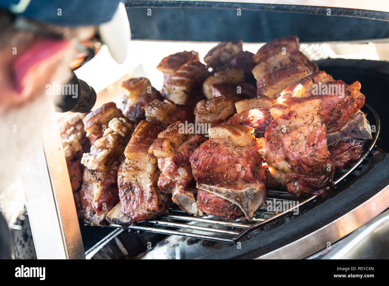 Fulda, Germany. 05th Aug, 2018. So-called 'Fraenkisches Schaeufele' lies on a grid in a kettle grill. Over 35 competition teams compete in two classes for the title of 'German BBQ King 2018'. Credit: Swen Pförtner/dpa/Alamy Live News Stock Photo