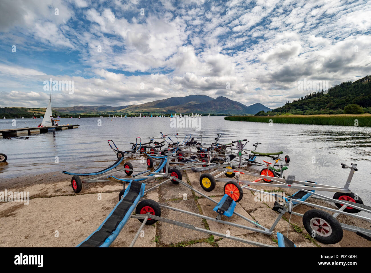 Bassenthwaite Lake, UK. 5th August, 2018. Good weather, but light winds, resulted in some early postponements on the second day of racing at Bassenthwaite Sailing Week. Hundreds of sail enthusiasts take part in the nine day event which is organised annually by Bassenthwaite Sailing Club in Cumbria. The backdrop of Skiddaw provides dramatic scenery for both sailors and spectators even if the good weather results in little wind power. This year the event runs from the 4th until the 12th of August. Photo Bailey-Cooper Photography/Alamy Live News Stock Photo