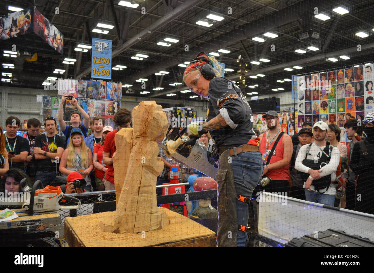 Austin, Texas, USA - Champion speed carver and chainsaw artist, Griffon,  demonstrates her talent for the crowd. Tens of thousands of fans gather for  RTX Austin, an annual gaming and Internet conventions
