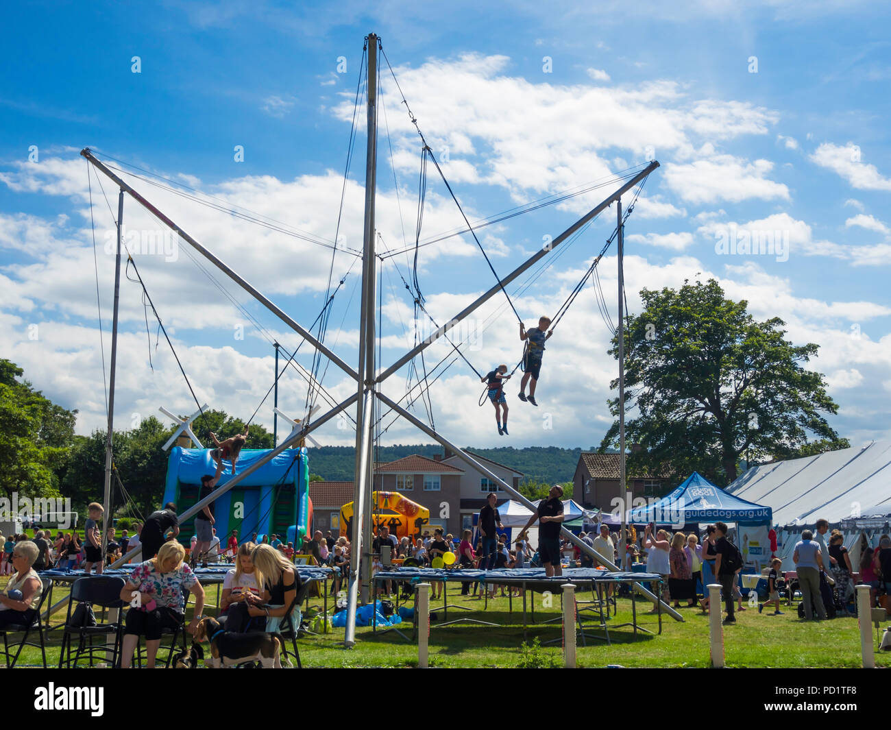 Children on a Bungee Trampolin at a Family Fun Day in North Yorkshire Stock Photo