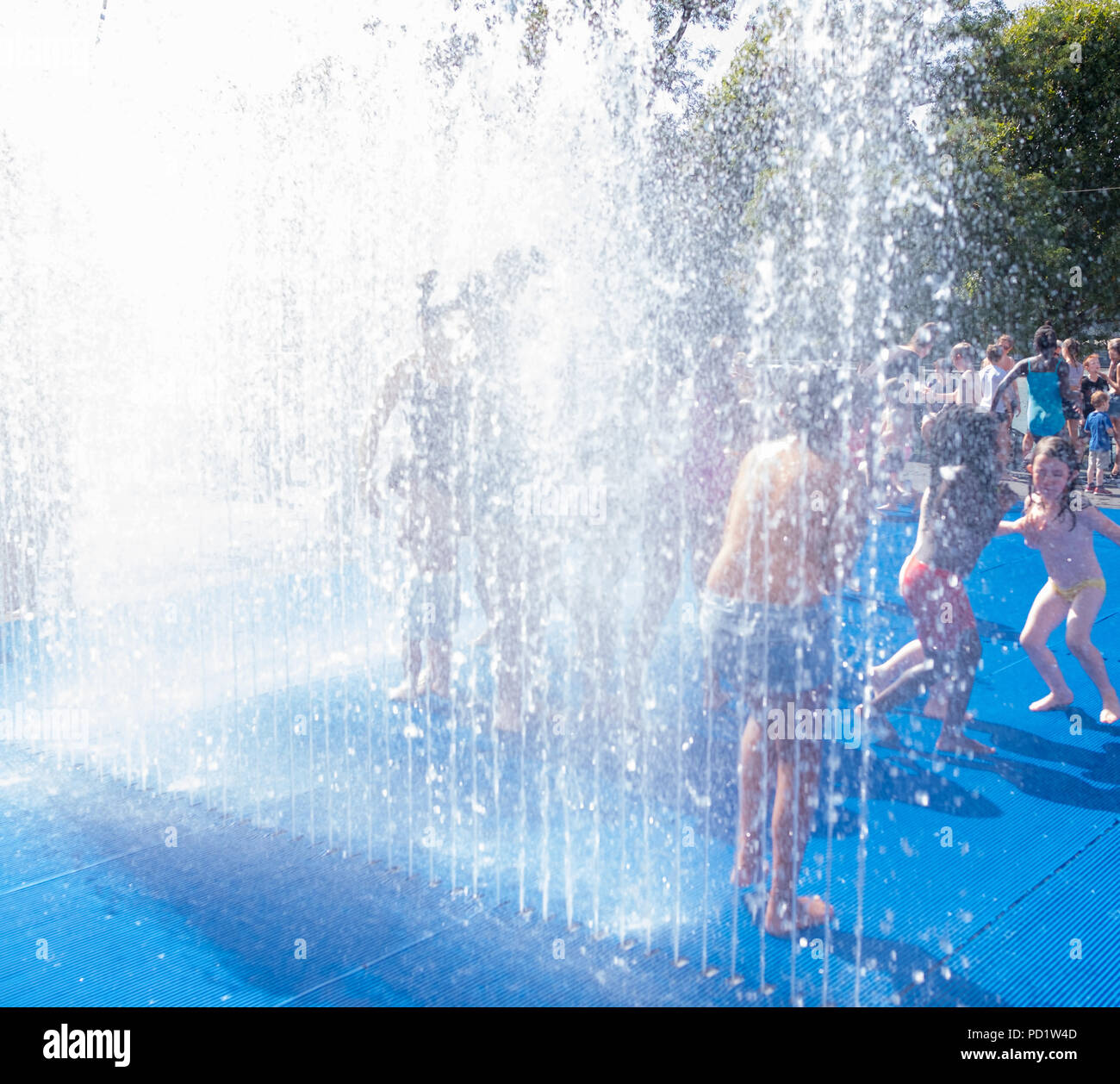 Children have fun and cool off during the summer heat wave in central London Stock Photo