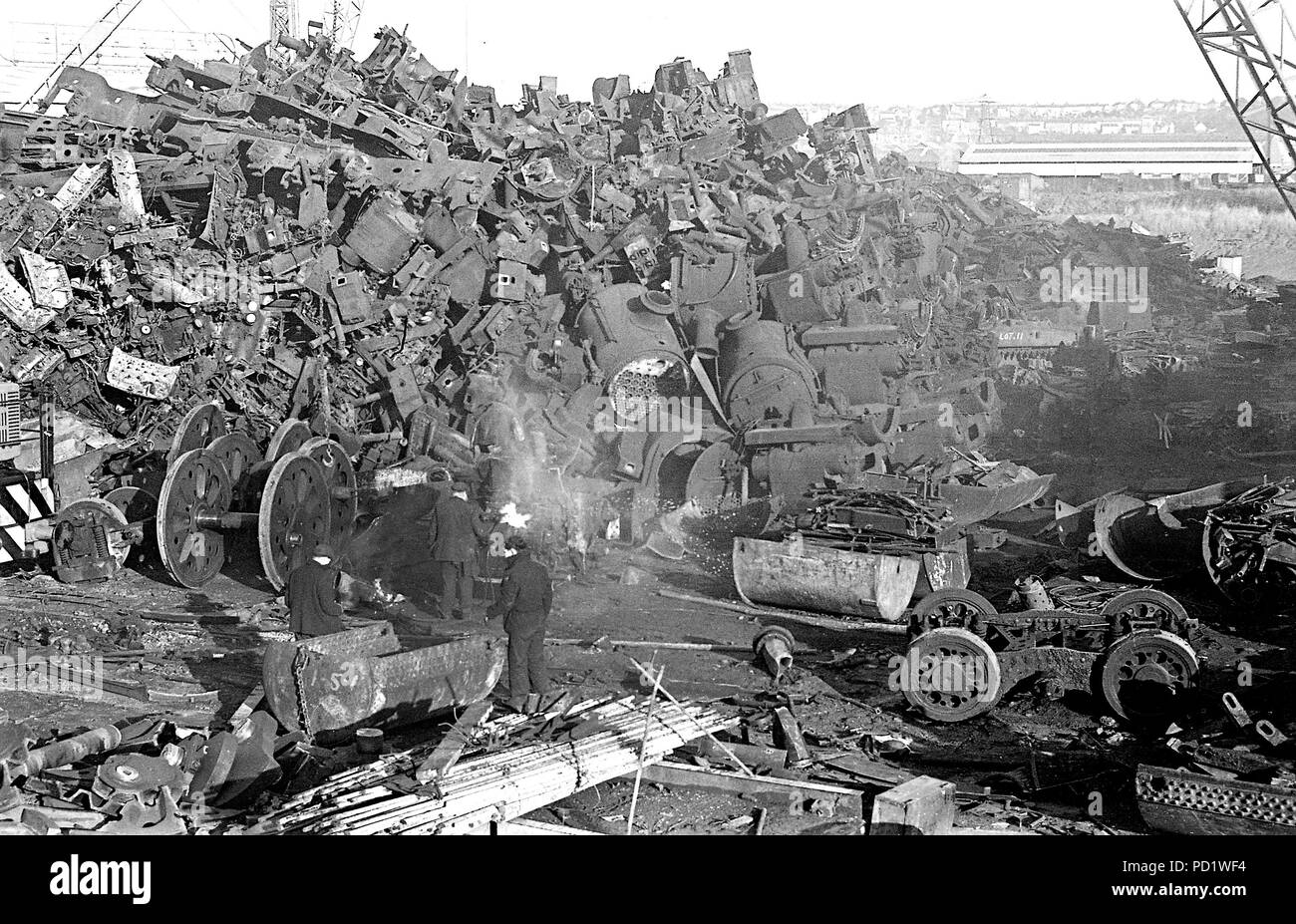 The scrapman's cutting torch is in action as an ex-British Railways Southern Region  Bulleid pacific steam locomotive is reduced to its last elements at Cashmore's scrapyard, Newport, adding to the ever-growing heap of steam engine bits Newport  29/12/1967 Stock Photo