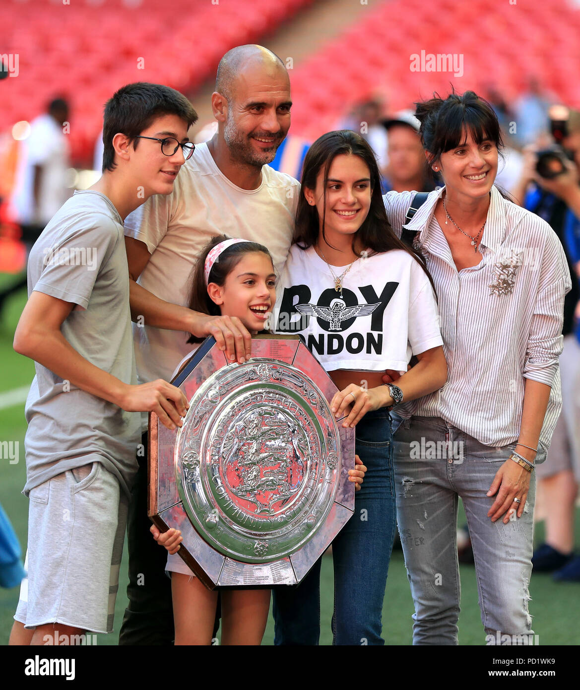 Manchester City manager Josep Guardiola with the Community Shield trophy and family wife Cristina Serra and children Valentina Guardiola, Maria Guardiola and Marius Guardiola after the Community Shield match at Wembley Stadium, London. Stock Photo