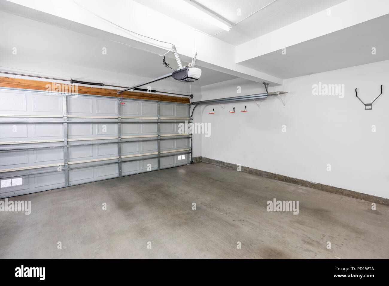 Empty residential garage in modern suburban home. Stock Photo