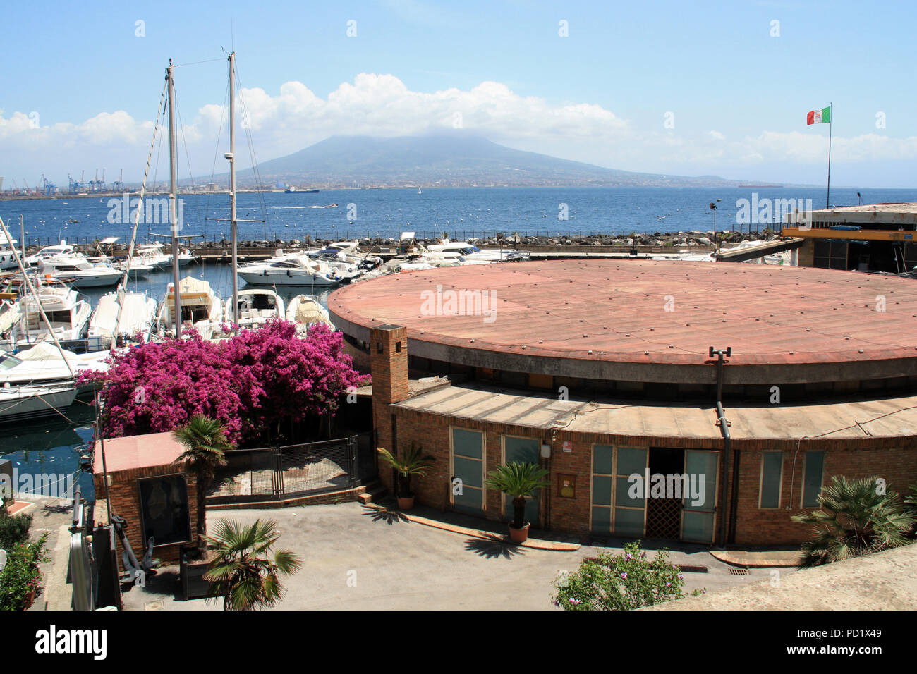 Recreational boats moored in a marina near the Castel dell'Ovo in Napoli, Italy, with the Mount Vesuvius in the background Stock Photo