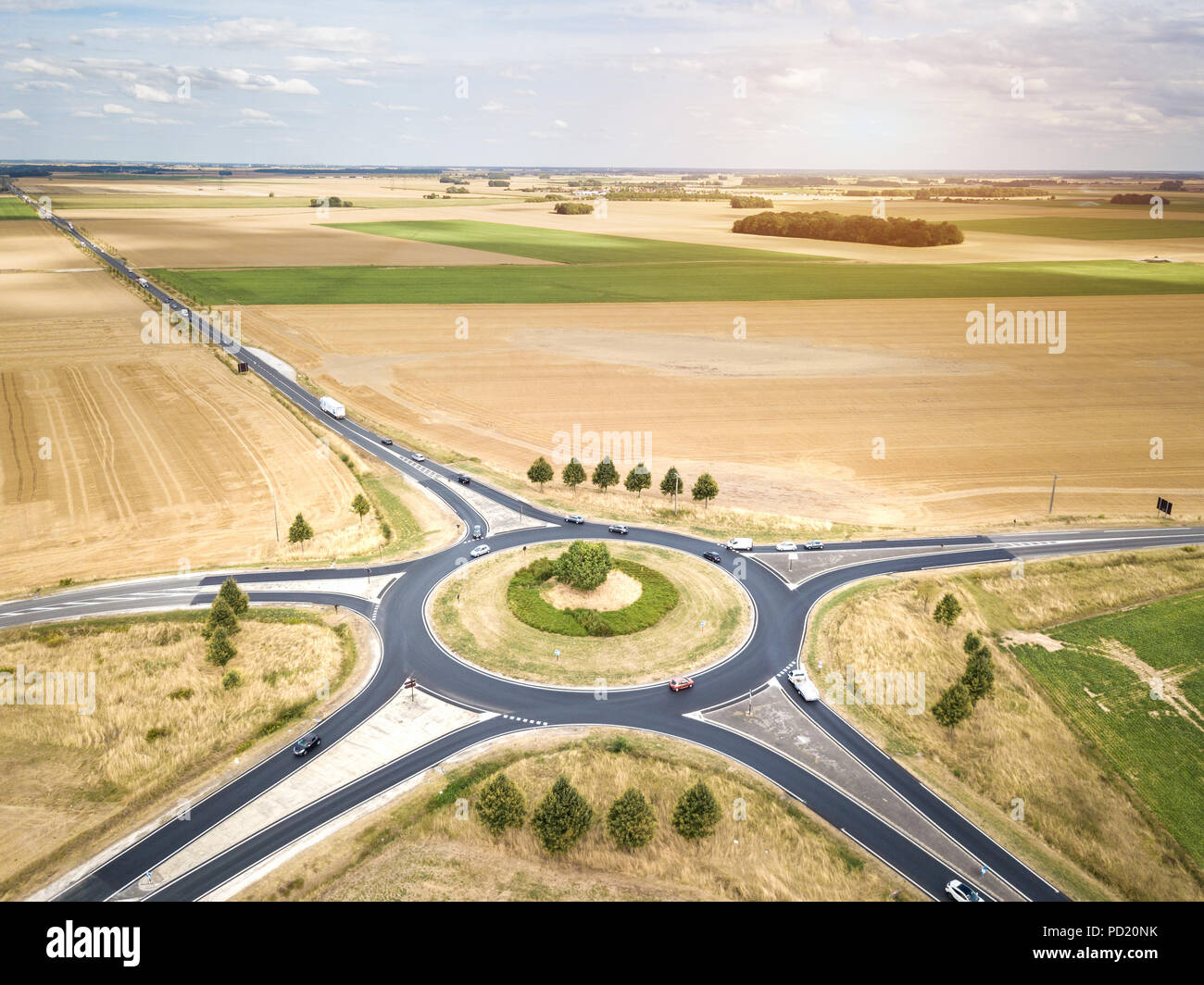 Roundabout drone aerial view with vehicles circling around the traffic circle lane, France country side rural road transportation, summer day, cars an Stock Photo