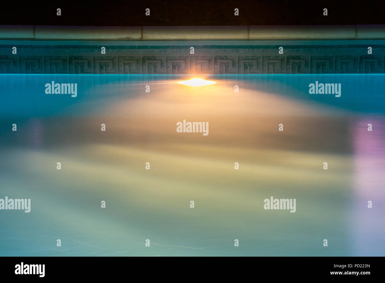 Beautiful blue liner swimming pool by night. Underwater lighting system