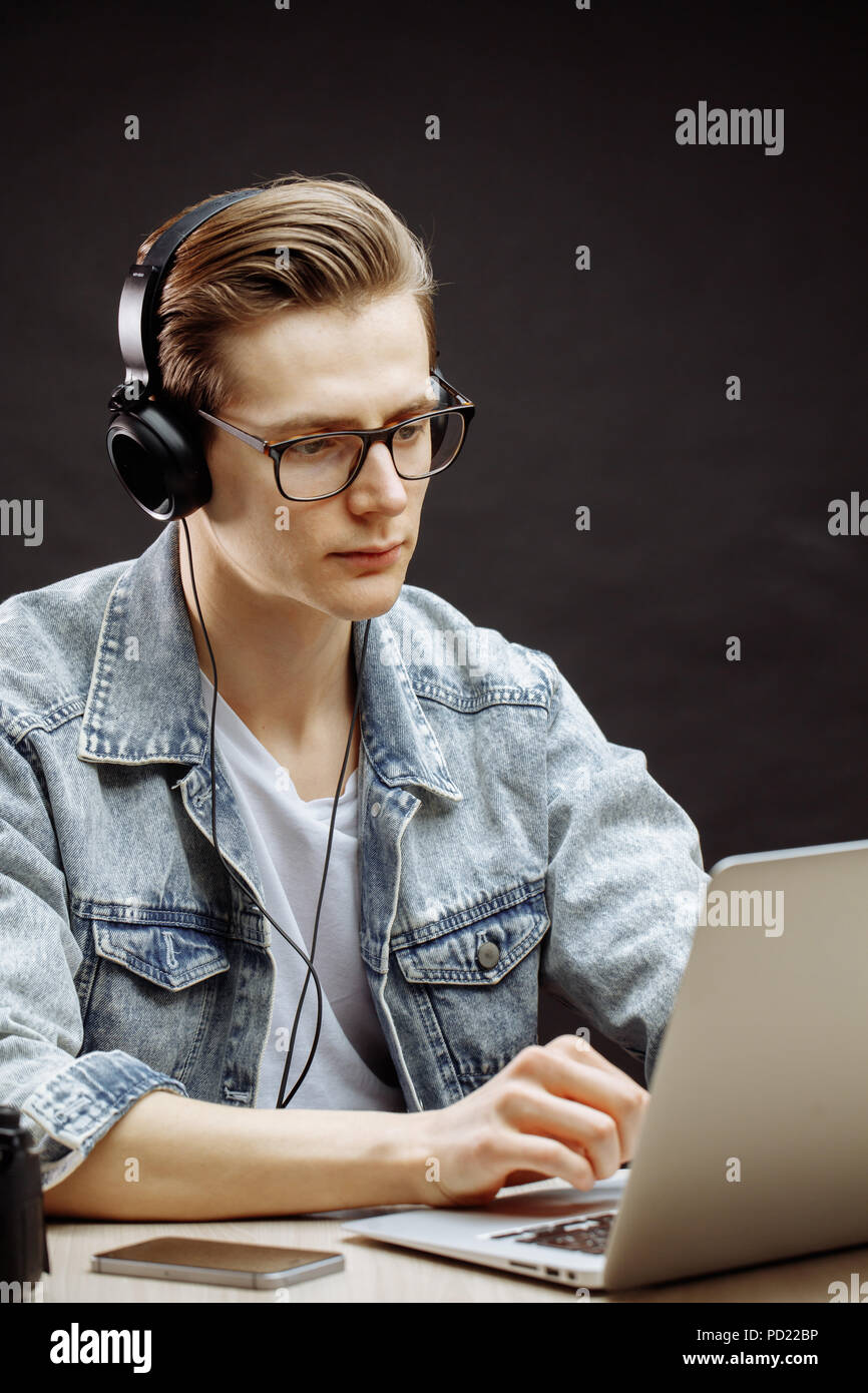 serious rewriter in denim jacket working with computer Stock Photo