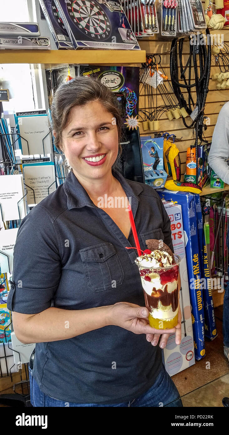 Camille Miller, owner of Mammoth Fun Shop in Mammoth Lakes, CA, holds her Baked Gorilla, a banana split in a cup...vanilla ice cream, pineapple, strawberries, hot fudge, whipped cream, peanuts & that chocolate cookie. Stock Photo