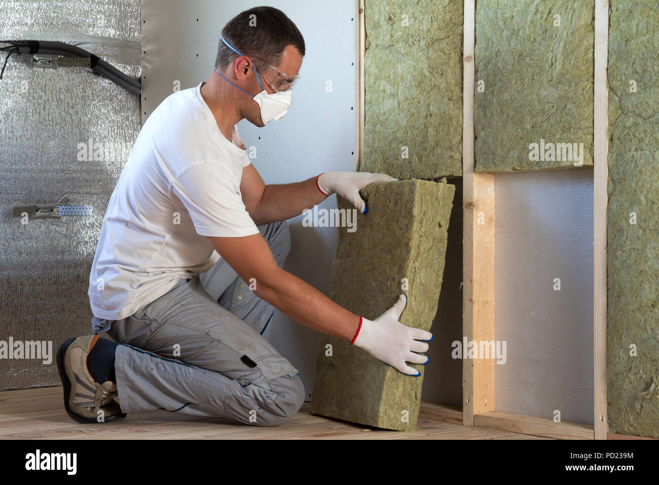 Respirator For Insulation Work Reference: Worker In Protective Goggles And Respirator Insulating Rock Wool