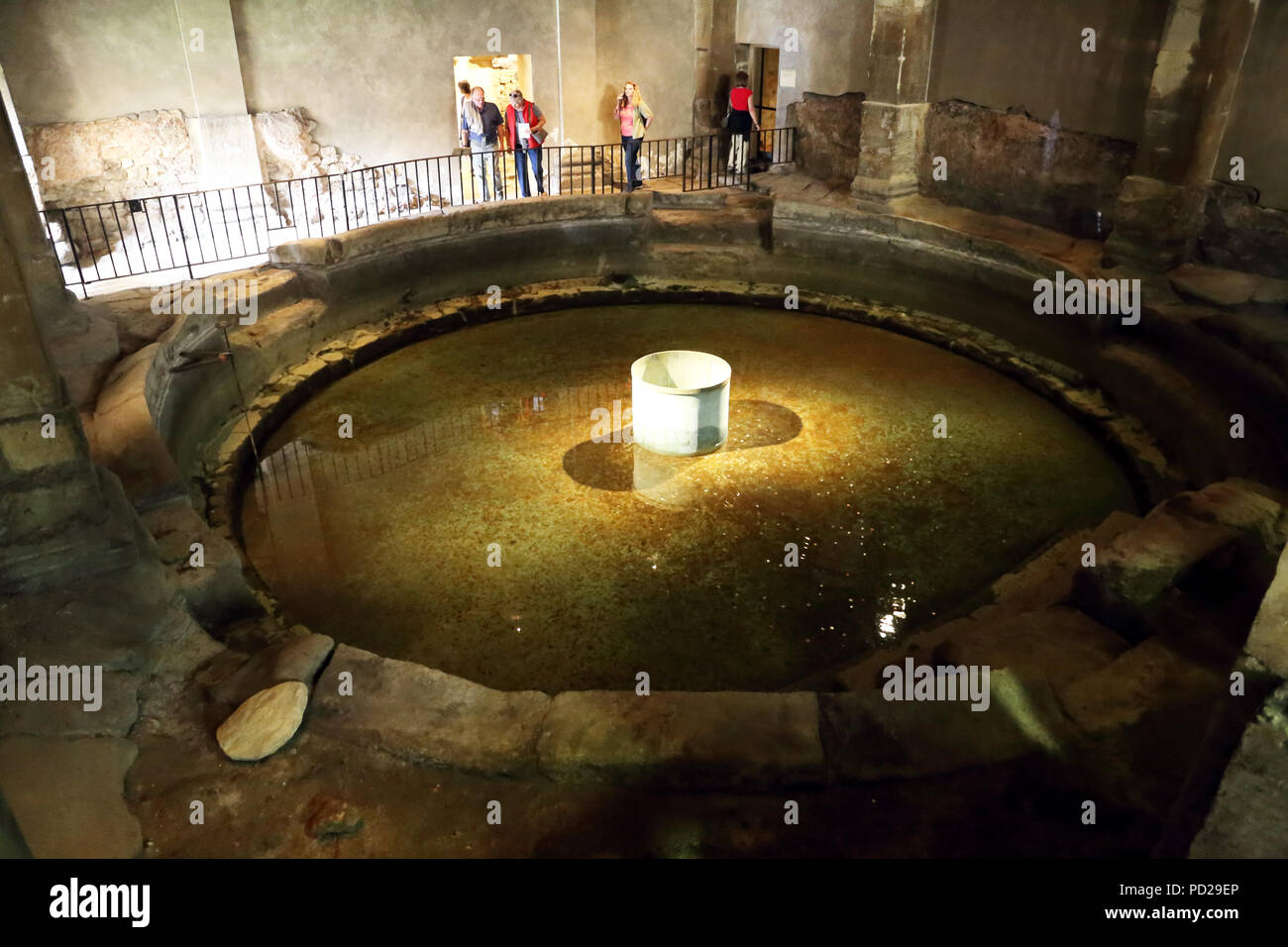 The circular frigidarium plunge pool at the Roman baths in Bath England. Stock Photo