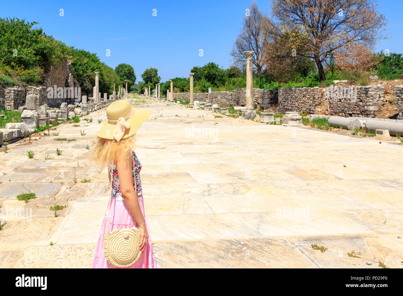 Young adult blonde looking at port route in Ephesus, Izmir, Turkey Stock Photo
