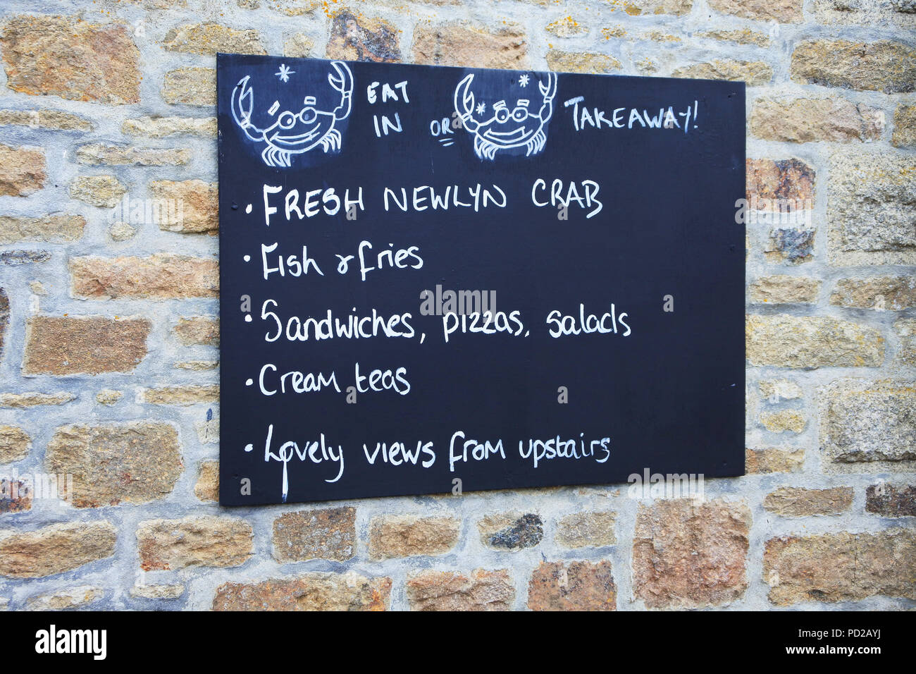 Wall mounted sign advertising takeaway food, Marazion, Cornwall, UK - John Gollop Stock Photo