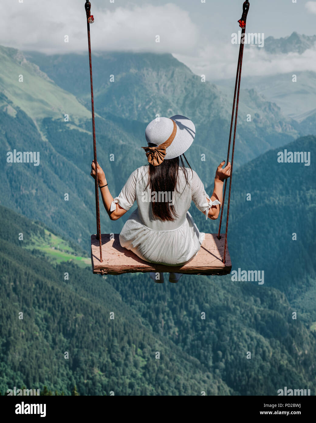 Freedom and carefree of a young female on a swing. Stock Photo