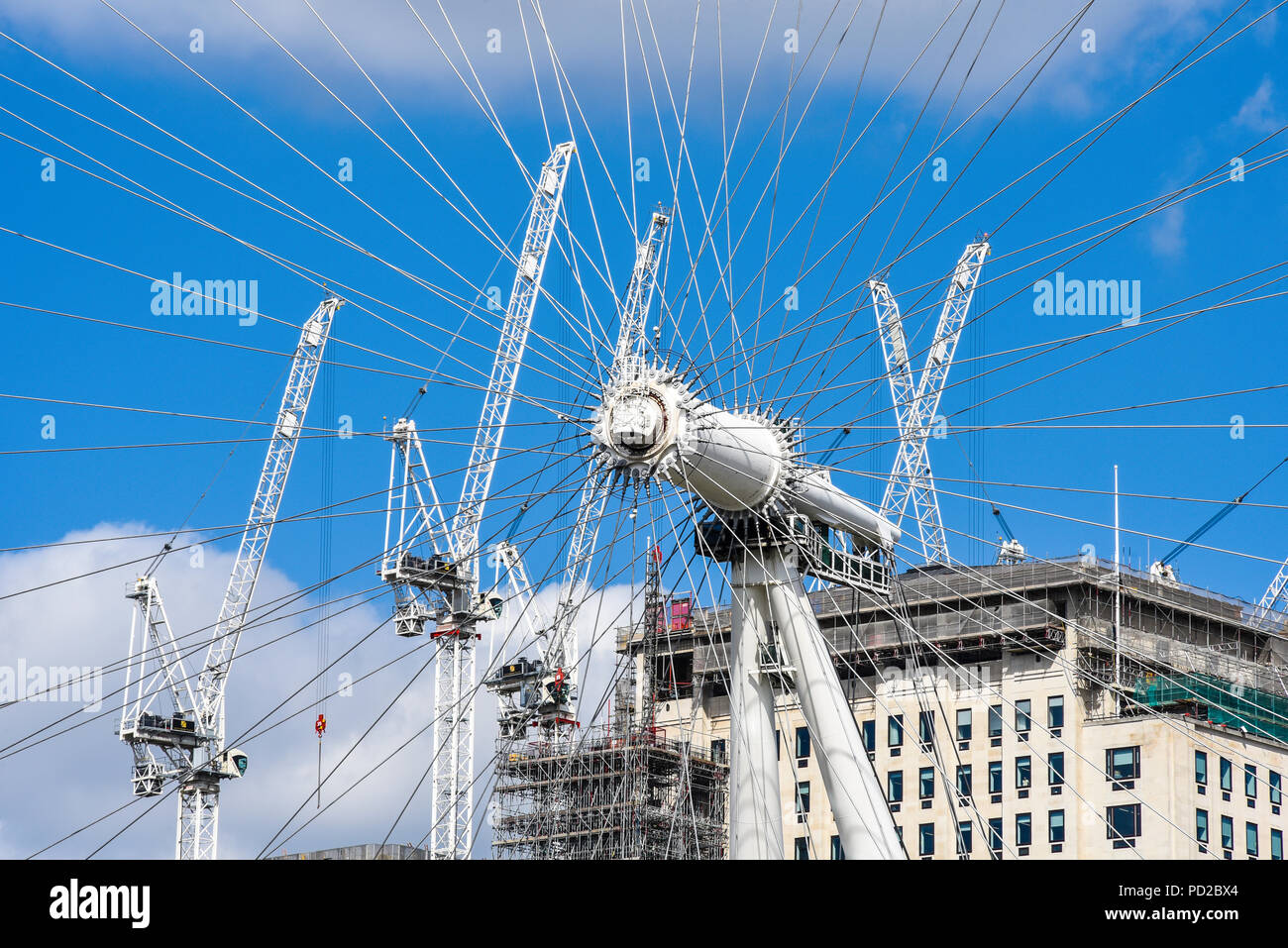 Millennium Wheel construction bracing wires with development cranes of building site of Southbank Place, London, UK. London Eye. Central spindle, hub Stock Photo