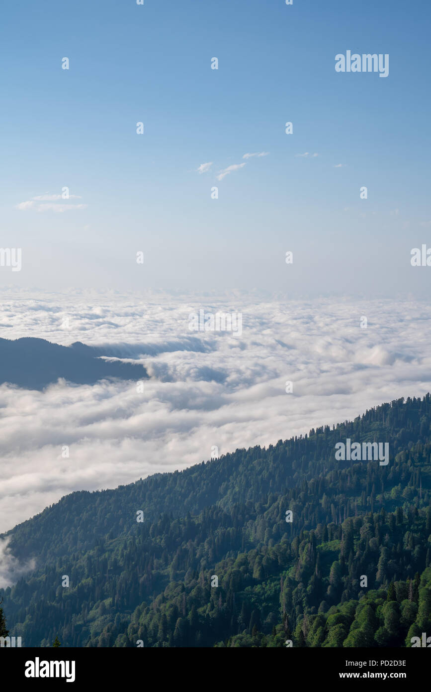 Mountain silhouette above the clouds at sunrise, view from the top view of mountains Stock Photo