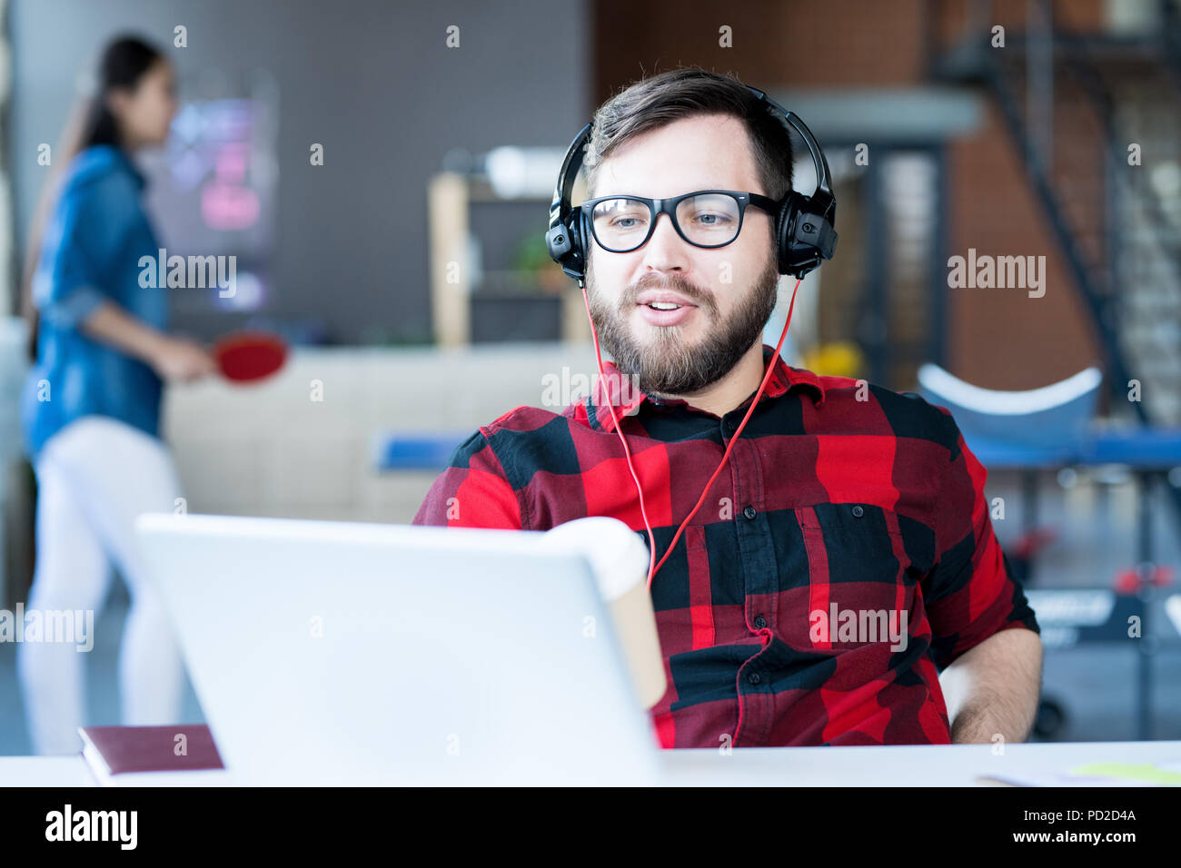 Modern Bearded Man Video chatting  in IT Office Stock Photo
