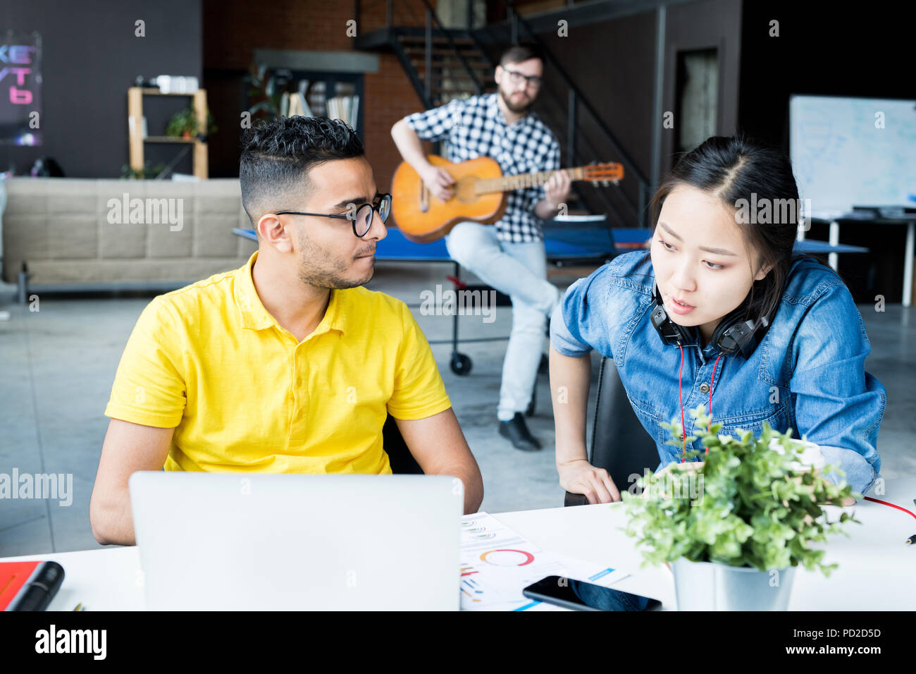 Multi-ethnic Business Team Discussing Work  in Office Stock Photo