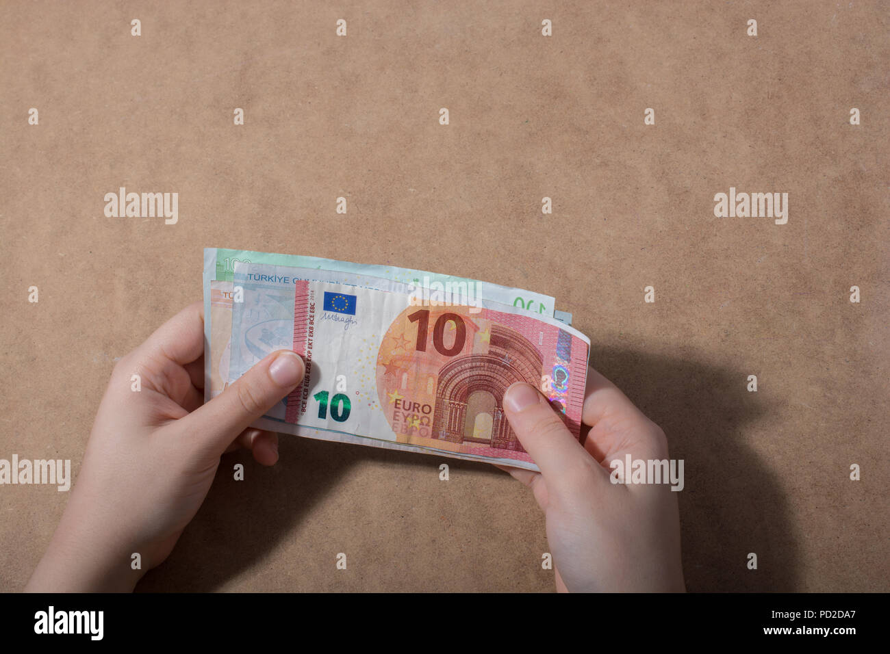 Hand holding American dollar banknotes isolated on wooden background ...
