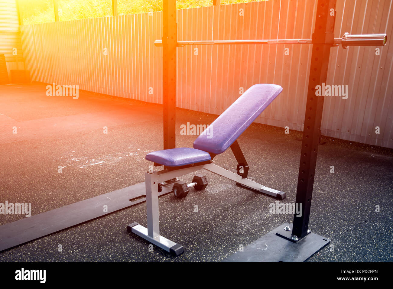 A Close Up Of A Metal Simulator In The Form Of A Bench With A Blue