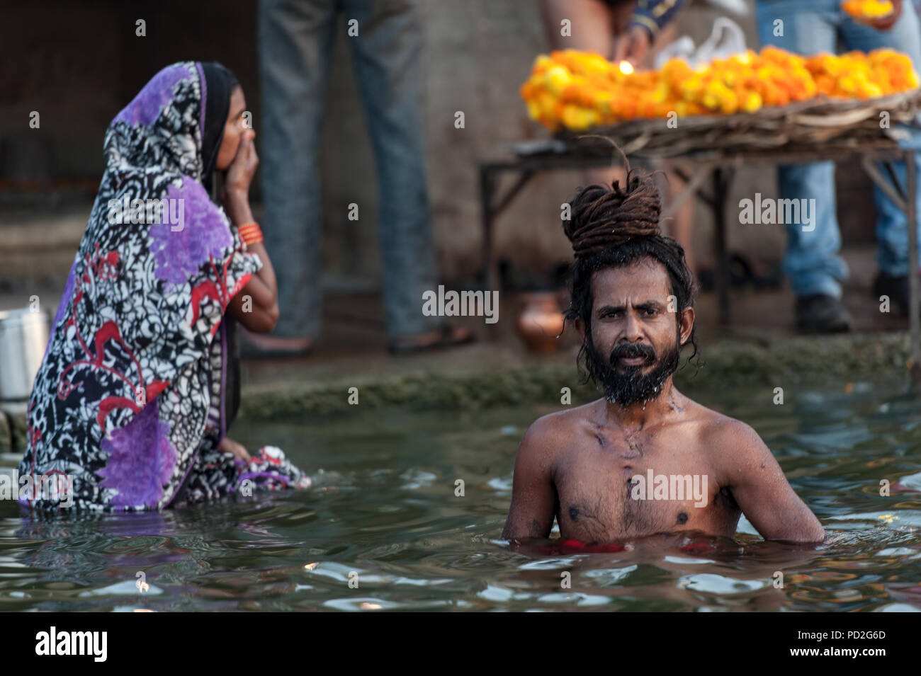 People bathe in the waters of the sacred Ganges in Varanasi, Uttar Pradesh, India Stock Photo