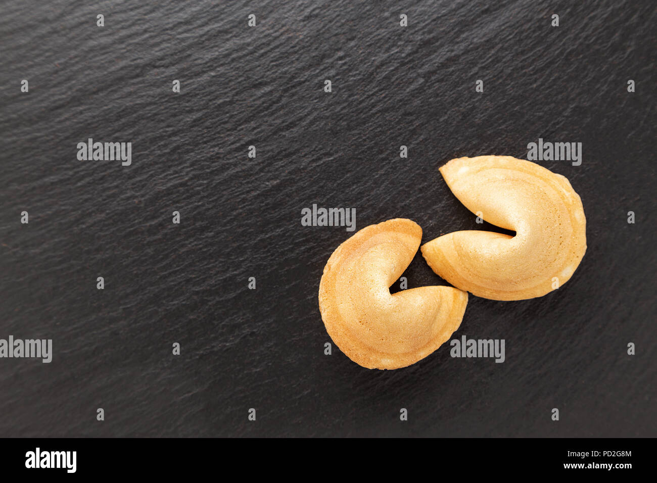 traditional Chinese pastry with the wishes or predictions on a black background Stock Photo