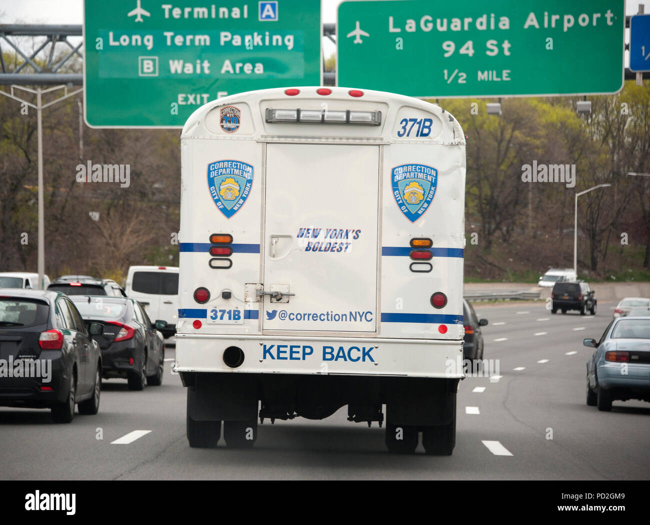 New York City Corrections bus on westbound side of Grand Central Parkway Stock Photo