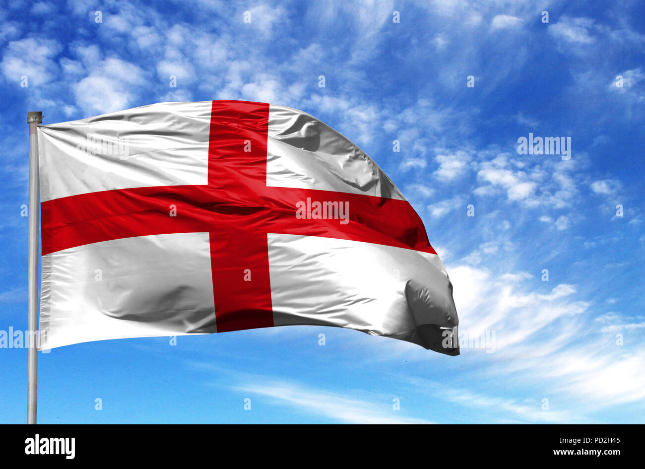 National flag of England on a flagpole in front of blue sky. Stock Photo
