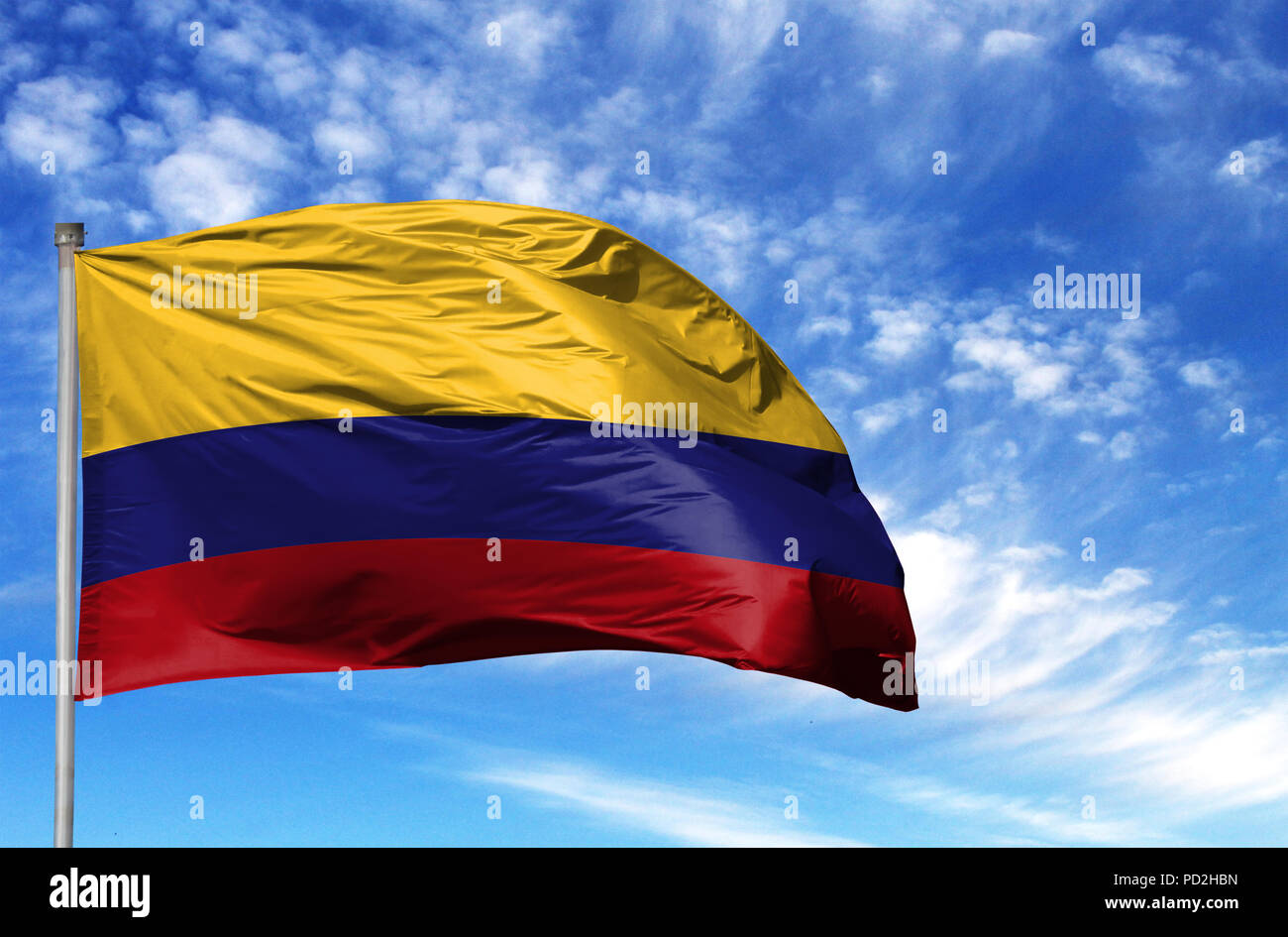 National flag of Colombia on a flagpole in front of blue sky. Stock Photo