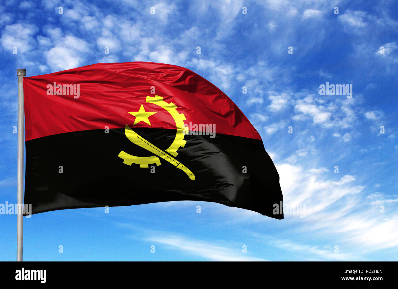 National flag of Angola on a flagpole in front of blue sky Stock Photo ...