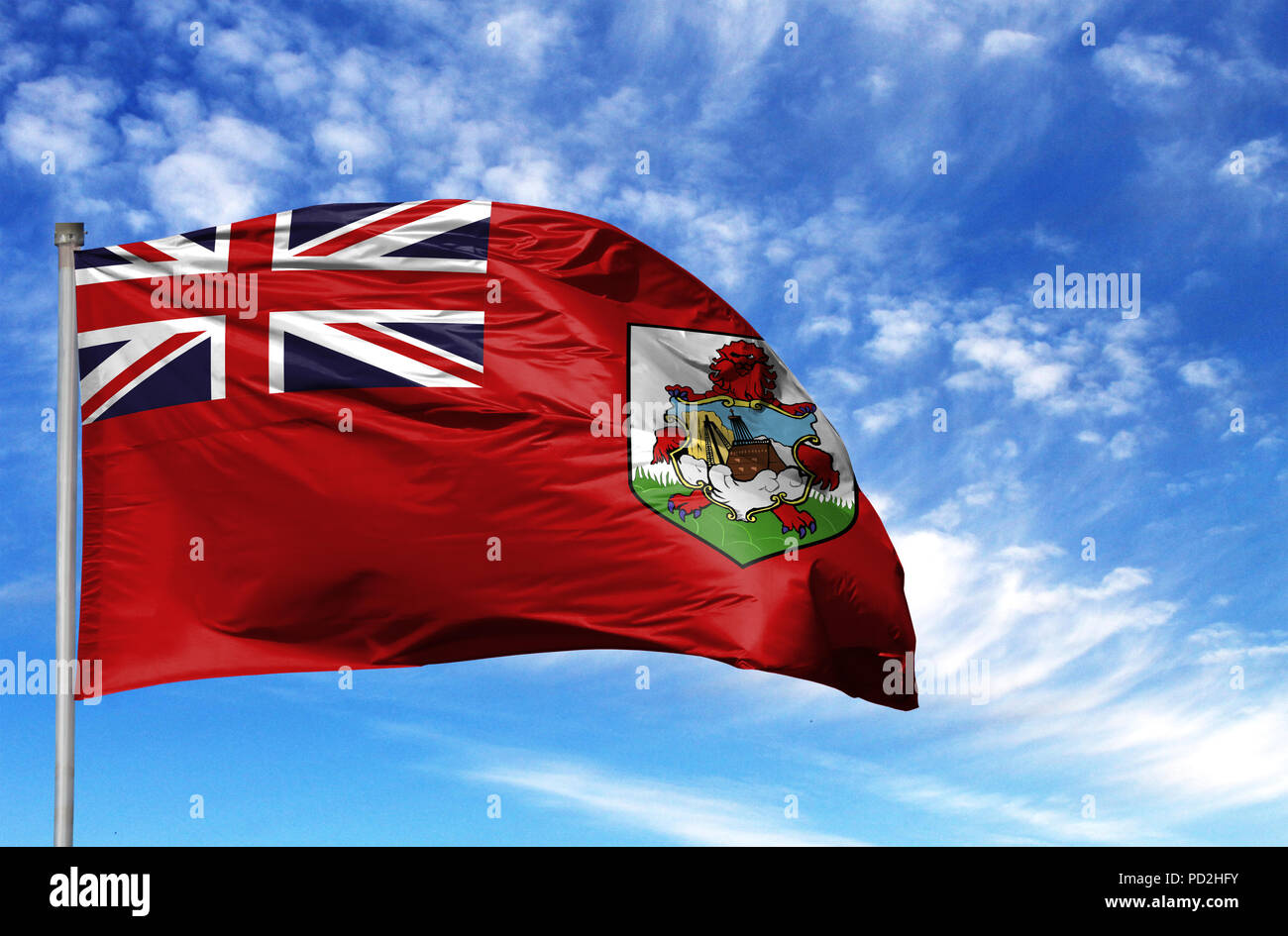 National flag of Bermuda Islands on a flagpole in front of blue sky. Stock Photo