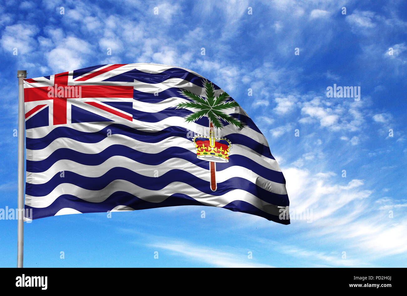National flag of British Territory in the Indian Ocean on a flagpole in front of blue sky. Stock Photo