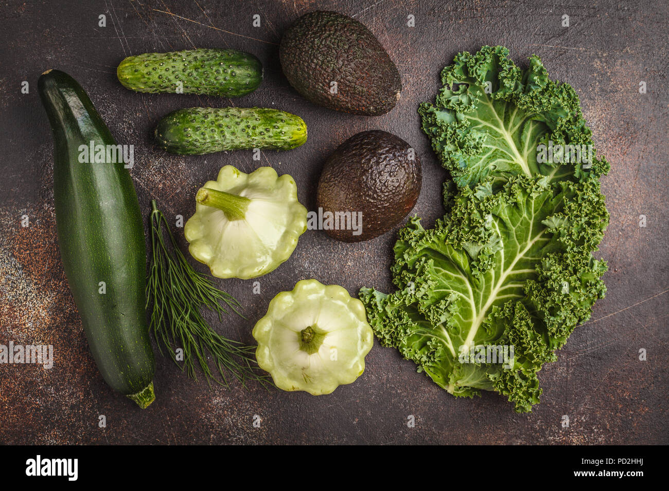 Assortment of green vegetables on dark background, top view. Fruits and