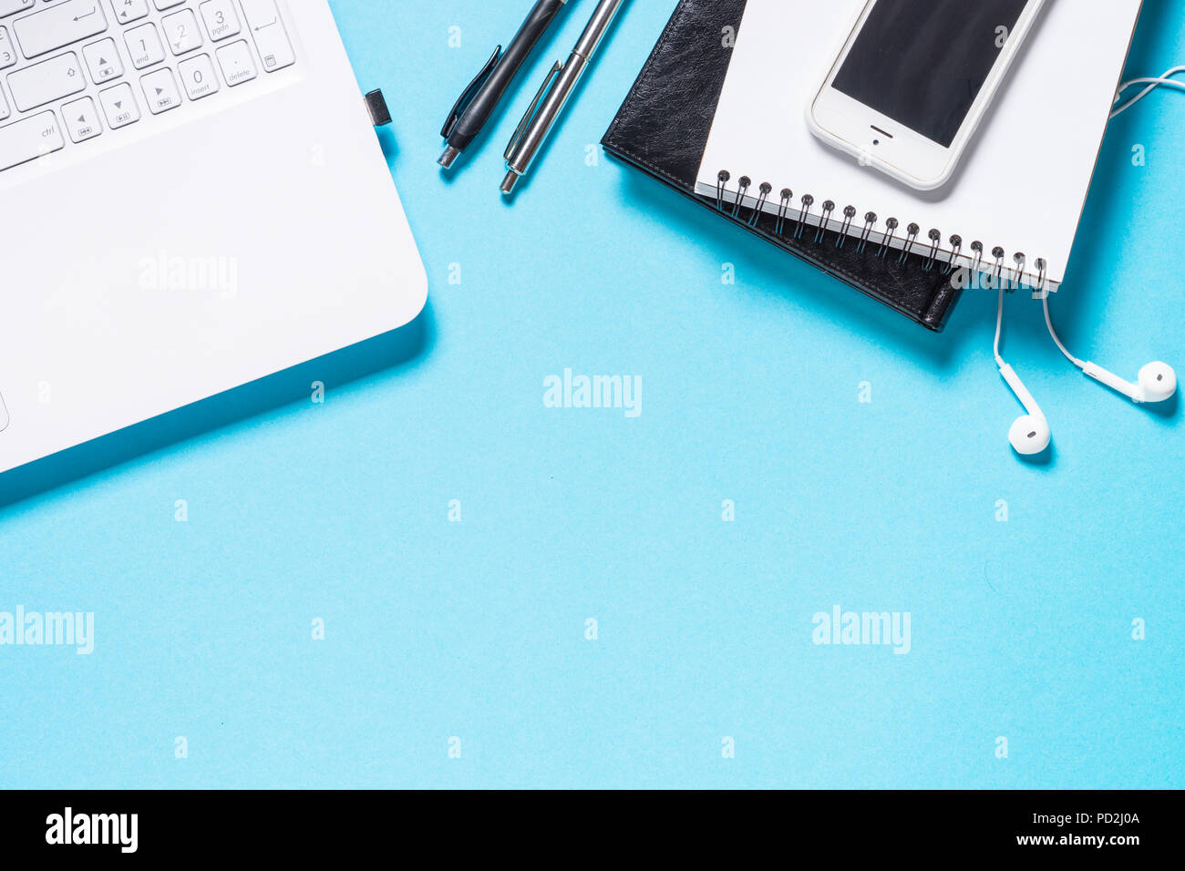 Laptop, notebook, pen, headphones and smartphone on blue backgro Stock ...
